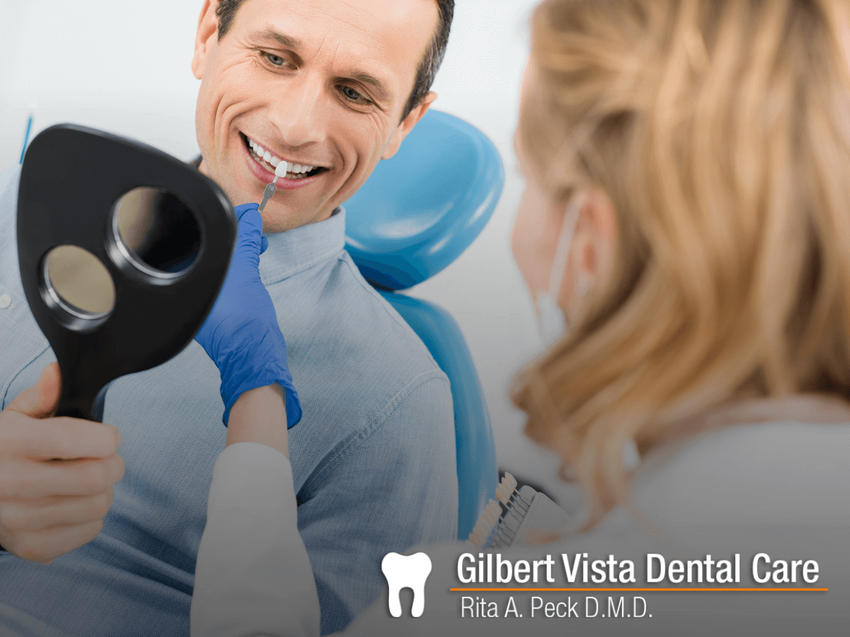 Man choosing a dental implant and looking at himself in the mirror at Gilber VIsta Dental Care