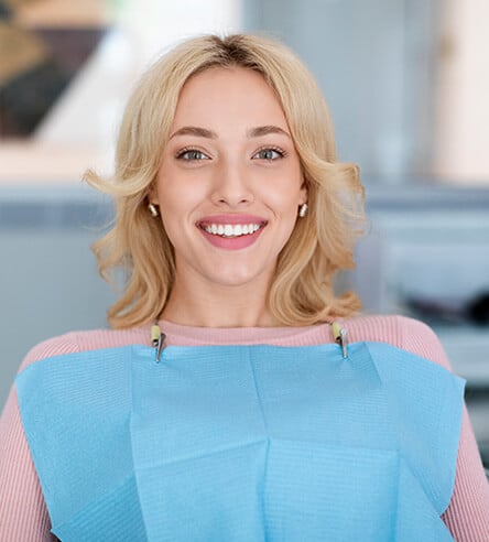woman with new dental crowns in Gilbert, AZ